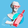 Female antique statue bust in fluffy sunglasses with hand holing bottle of wine over blue background. Contemporary art