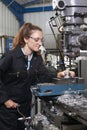 Female Apprentice Engineer Working On Drill In Factory Royalty Free Stock Photo