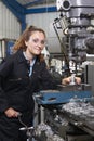 Female Apprentice Engineer Working On Drill In Factory Royalty Free Stock Photo