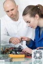 Female apprentice learning to use multimeter Royalty Free Stock Photo