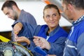 Female apprentice mechanic smiling at supervisor Royalty Free Stock Photo