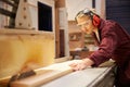 Female Apprentice Using Circular Saw In Carpentry Workshop