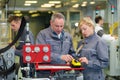 female apprentice and worker using machine in factory Royalty Free Stock Photo