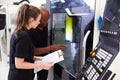 Female Apprentice Working With Engineer On CNC Machinery Royalty Free Stock Photo