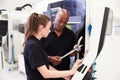 Female Apprentice Working With Engineer On CNC Machinery Royalty Free Stock Photo
