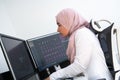 Female Arabic creative professional working at home office on desktop computer with dual screen monitor top view Royalty Free Stock Photo