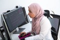 Female Arabic creative professional working at home office on desktop computer with dual screen monitor top view Royalty Free Stock Photo