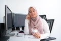 Female Arabic creative professional working at home office on desktop computer with dual screen monitor top view Royalty Free Stock Photo