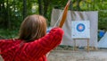 Female archer with wooden bow