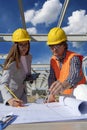 Female Architect and Engineer Checking the Construction Blueprint on Construction Site Royalty Free Stock Photo