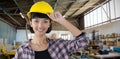 Composite image of female architect in hard hat standing against white background Royalty Free Stock Photo