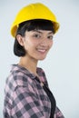 Female architect in hard hat standing against white background Royalty Free Stock Photo