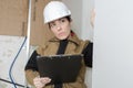 Female architect with hardhat taking notes Royalty Free Stock Photo