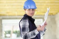 Female architect holding plans in property Royalty Free Stock Photo