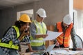 female architect holding walkie talkie and male civil engineer with working together inspection housing estate project Royalty Free Stock Photo