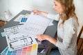 Female architect look at blueprint, reading technical drawing Royalty Free Stock Photo