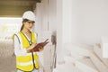 Female architect inspecting aerated concrete blocks used in wall construction and construction. Royalty Free Stock Photo