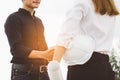 Female architect shaking hands with client in construction site after confirm blueprint for renovate building Royalty Free Stock Photo