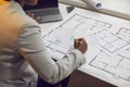 Woman architect working on blueprints and using urban plans and cadastral city maps Royalty Free Stock Photo