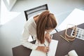 Female architect sitting in an office working on a project