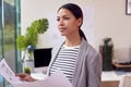 Female Architect Standing In Office Looking At Building Plans Royalty Free Stock Photo