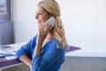 Female architect talking on mobile phone in office Royalty Free Stock Photo