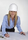 Female architect working on blue prints Royalty Free Stock Photo