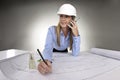 Female architect working on blue prints Royalty Free Stock Photo