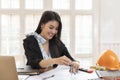 Female architect working on blueprint architects project in office Royalty Free Stock Photo