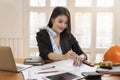 Female architect working on blueprint architects project in office Royalty Free Stock Photo