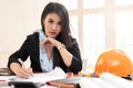 Female architect working on blueprint architects project in office Royalty Free Stock Photo