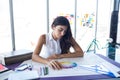 Female architect working on blueprint at her desk Royalty Free Stock Photo