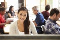 Female Architect Working At Desk With Meeting In Background Royalty Free Stock Photo