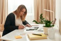 Female architect working from home. Young woman interior designer working on project while sitting at her creative Royalty Free Stock Photo