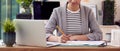 Female Architect Working In Office Sitting At Desk Studying Plans For New Building Royalty Free Stock Photo