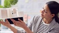 Female Architect Working In Office Studying Model Of New Building Royalty Free Stock Photo