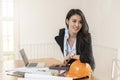 Female architect working standing at her desk with blueprint architects project in vintage office Royalty Free Stock Photo