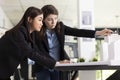 Female architects making necessary adjustments on 3d building model Royalty Free Stock Photo