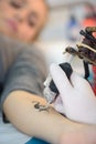 female arm being tatooed Royalty Free Stock Photo