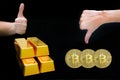 Female arm show OK on four golden bullions and Female arm show thumb down sign on virtual currency bitcoin isolated on black Royalty Free Stock Photo