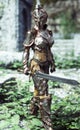 Female armored knight with sword on patrol.