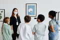 Female Art Expert Talking to Kids in Gallery