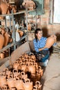 Female artisan inspecting finished production