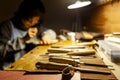 Female artisan violinmaker while viewing a new violin