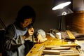 Female artisan violinmaker while viewing a new violin