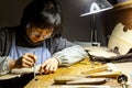 Female artisan violinmaker while viewing a new violin