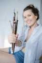 Female artist hand painter with brushes in front of the canvas a