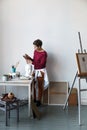 Female artist in her spacious white studio Royalty Free Stock Photo
