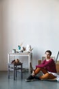 Female artist in her spacious white studio working with watercolor painting Royalty Free Stock Photo