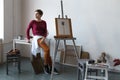 Female artist in her spacious white studio working with watercolor painting Royalty Free Stock Photo